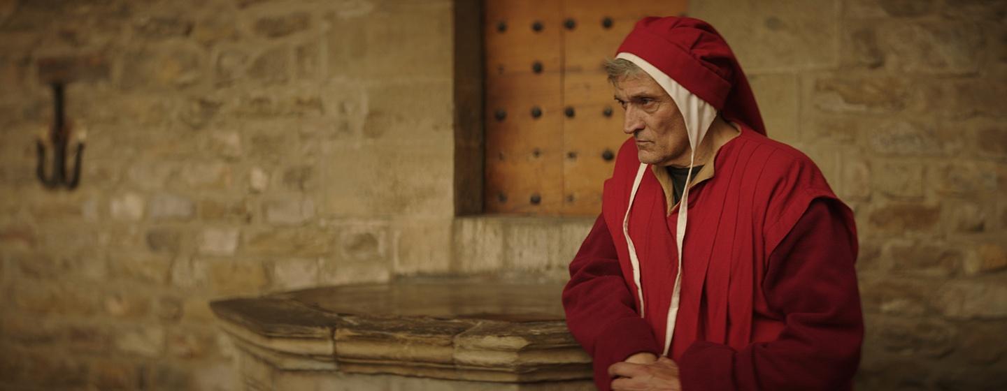 Antonio Fazzini as Dante Alighieri. Original footage shot on location outside Casa di Dante, Florence.