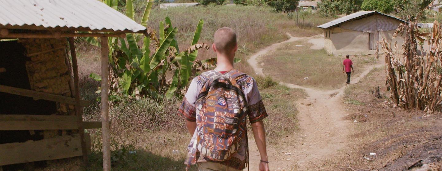 Peace Corps volunteer Kris Keenan in his village