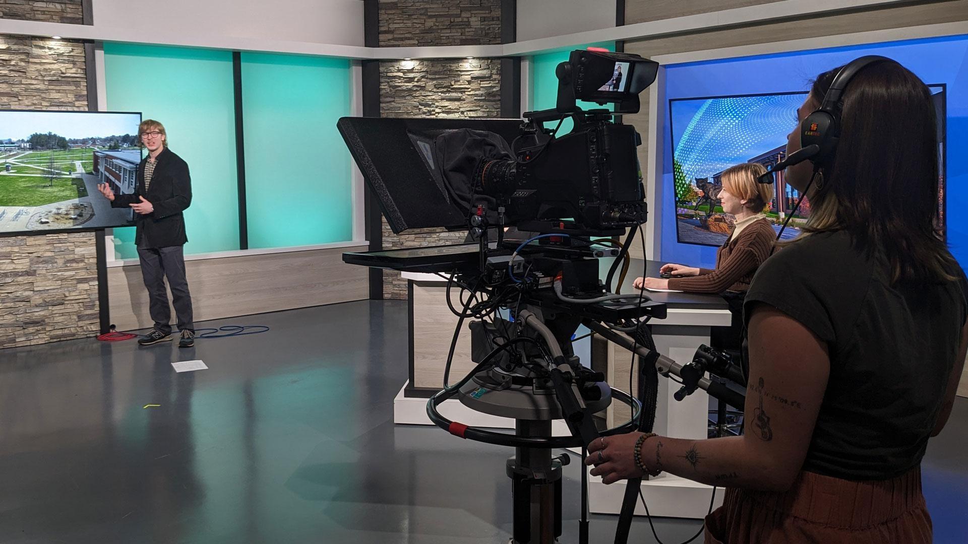 WNMU-TV on-air production with camera operator and news broadcast set