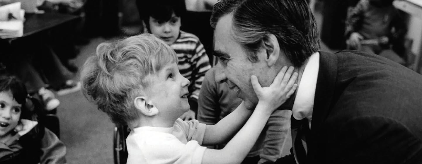 Photo of Fred Rogers and small child
