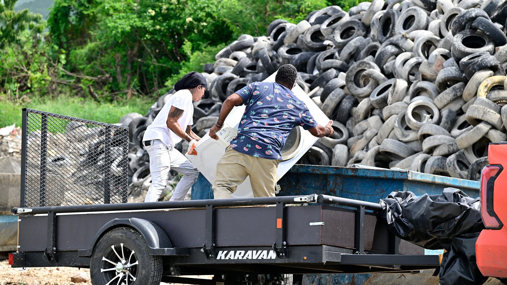 A garbage hauler with contractor Marco St. Croix