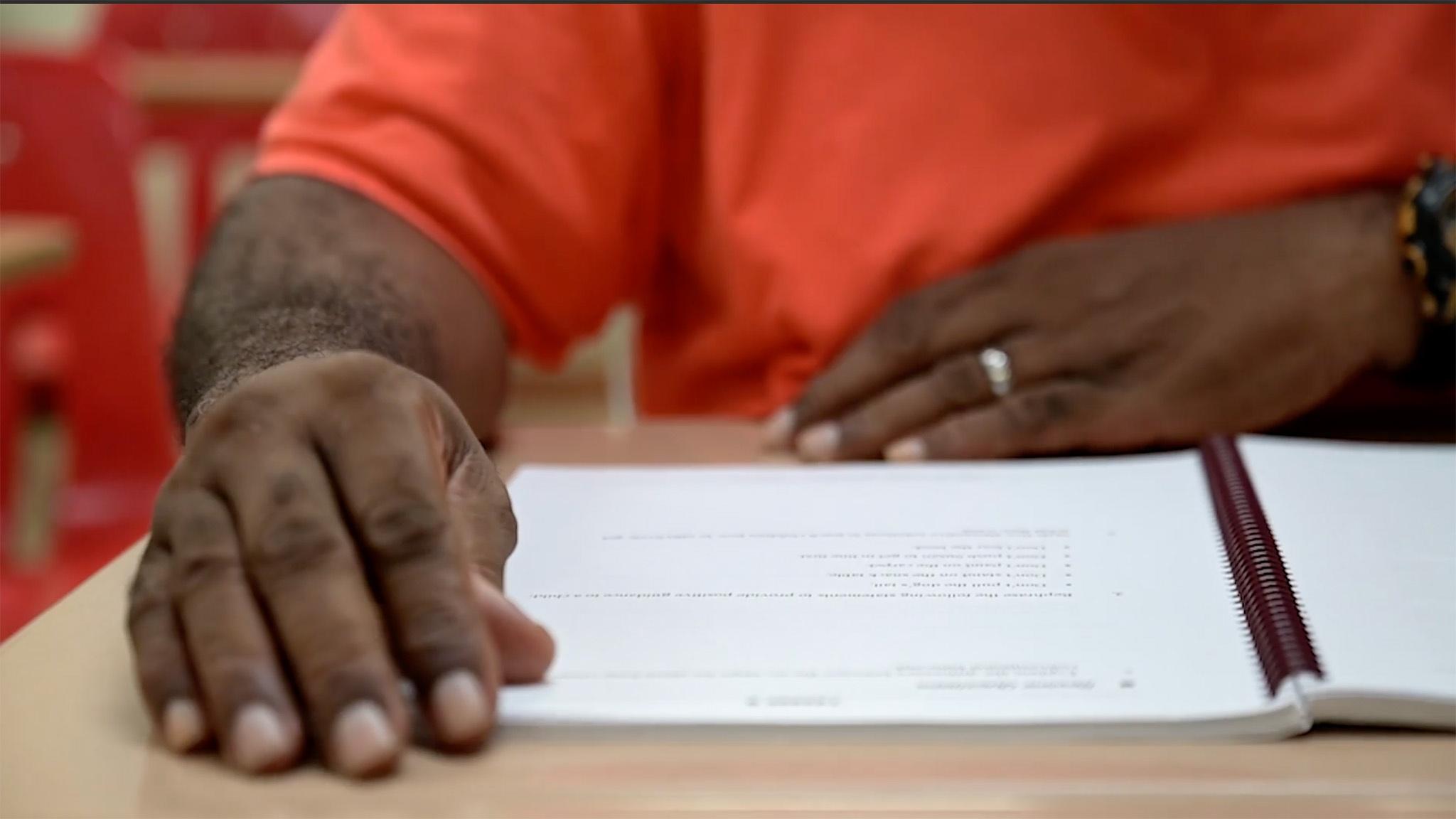 Prisoner signing papers