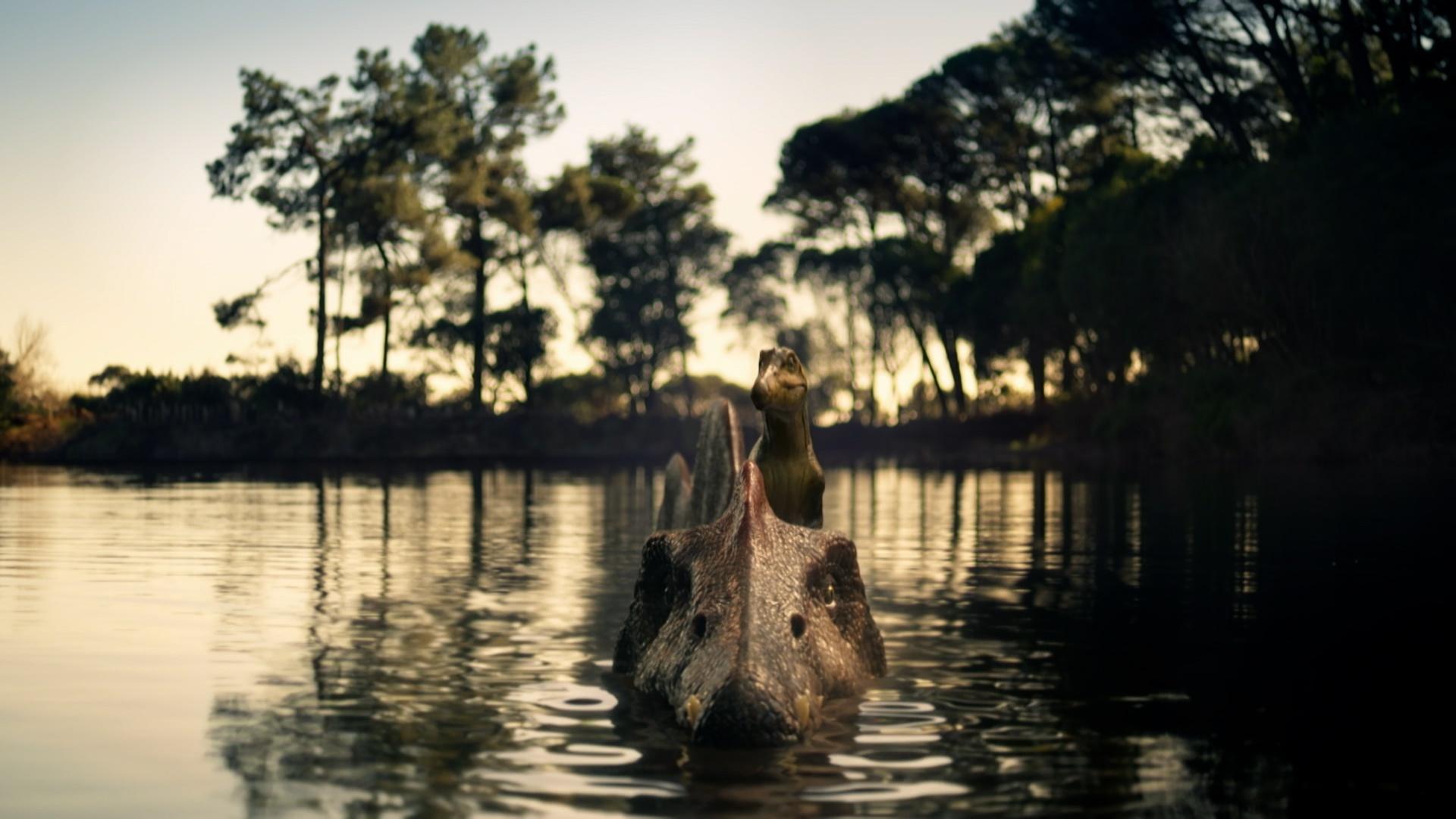A dinosaur head just poking out of the water.