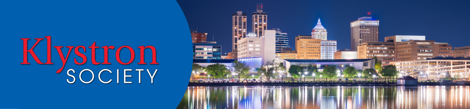 Klystron Society header featuring a night skyline of Peoria reflected in the Illinois River
