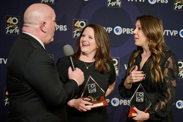 Mark Welp interviewing class of 2025 members, Laura Burke and Kate Carter in front of a WTVP / 40 Leaders background.