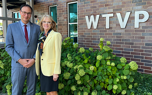 Daniel Aschheim and Lesley Matuszak standing in front of the WTVP building