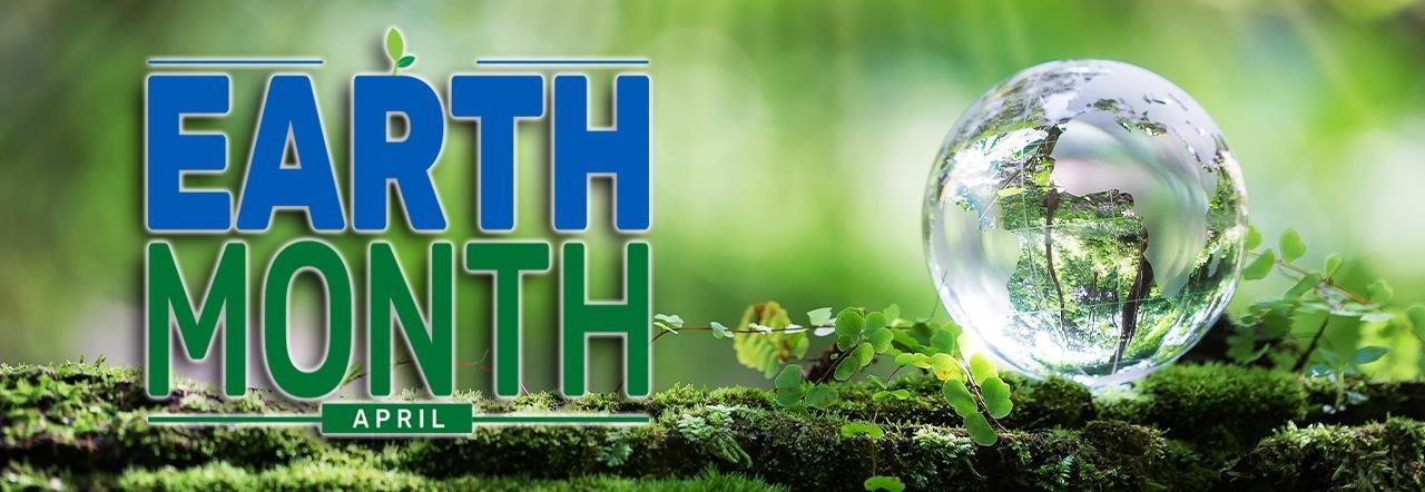 ext: Earth Month | April, over a green blurred background with a small glass globe sitting on a moss covered log.