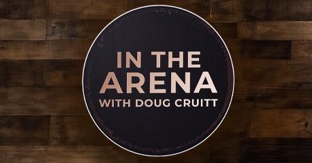 In The Arena with Doug Cruitt written in copper encircled over a wooden background