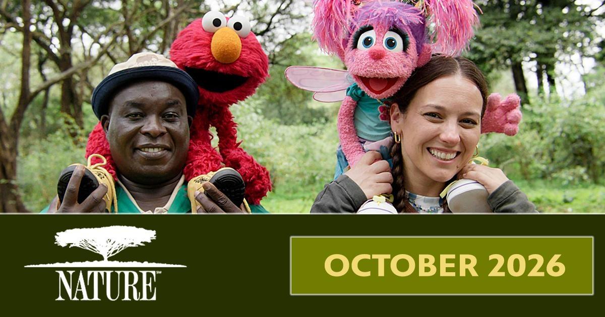 Nature October 2026 banner featuring Elmo and Abby Cadabby with two smiling people in a wooded setting.