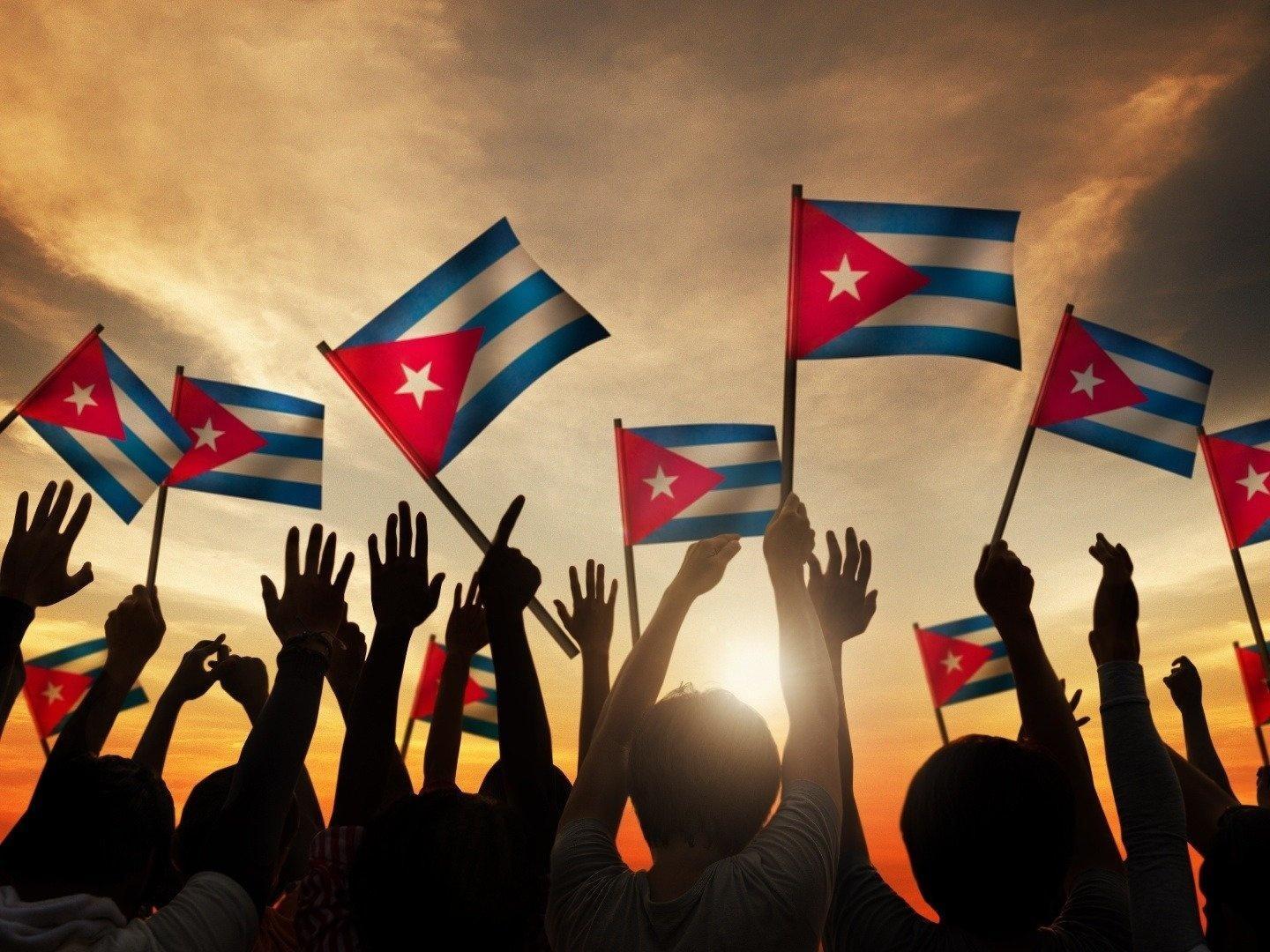 Cuban flags held aloft.