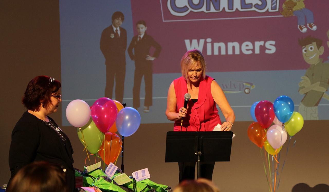 Mary announcing the first winner at 2017 Writers Contest Event