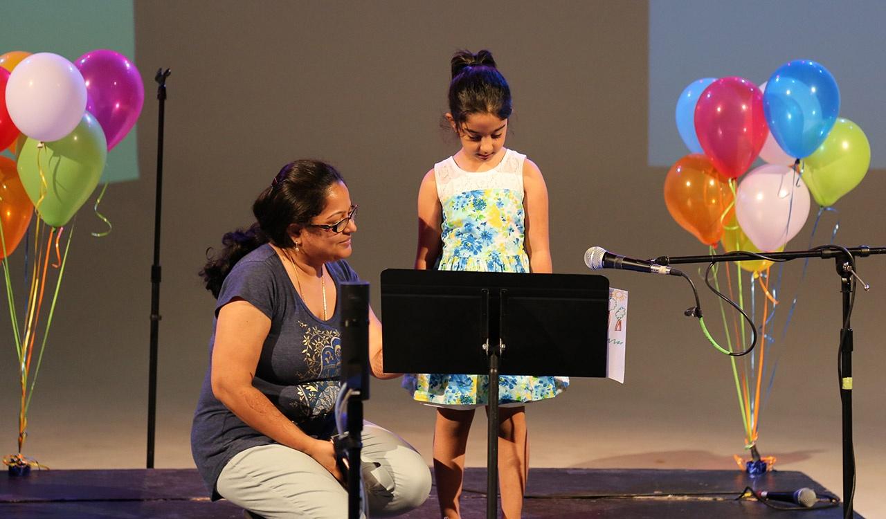 Contest Winner reads her story onstage with mom