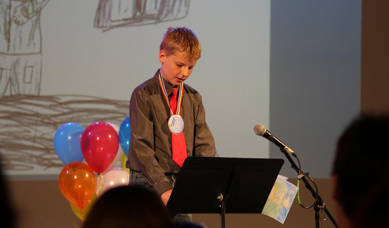 First Place 3rd Grade winner reads his story onstage in the studio at 2017 Writers Contest