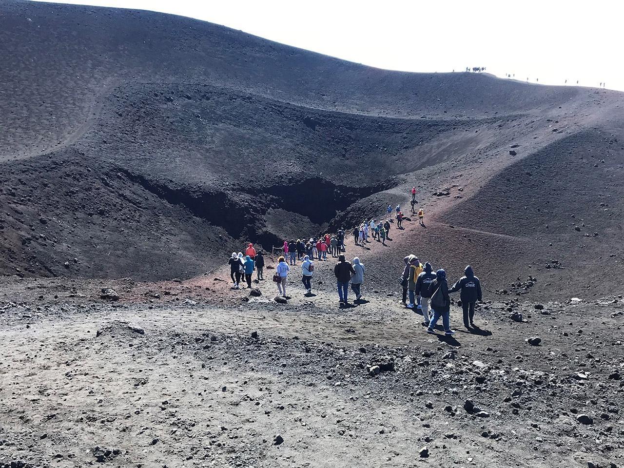 Wide shot of Travels walking up rocky slope