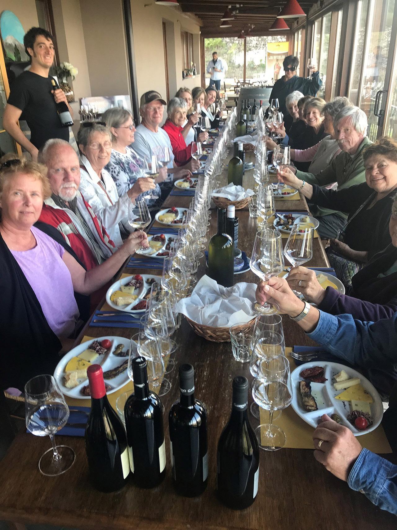 Travelers sitting at long table about to start eating.