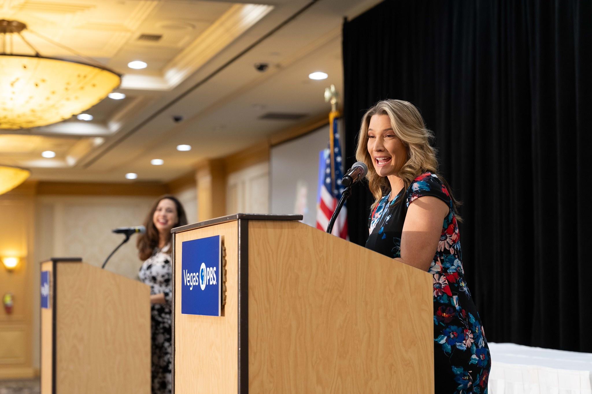 Maria Silva and Amber Renee Dixon standing behind Vegas PBS podiums