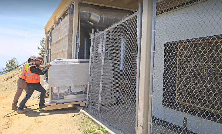 Engineers working on Deer Point transmitter in June, 2025