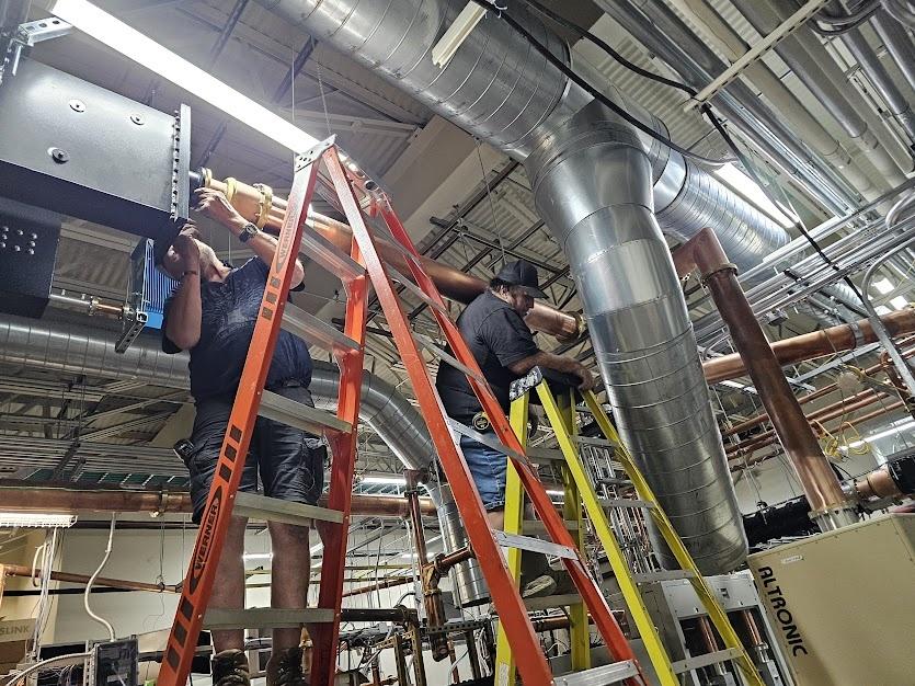 The crew works on equipment at Deer Point transmitter site, July, 2025