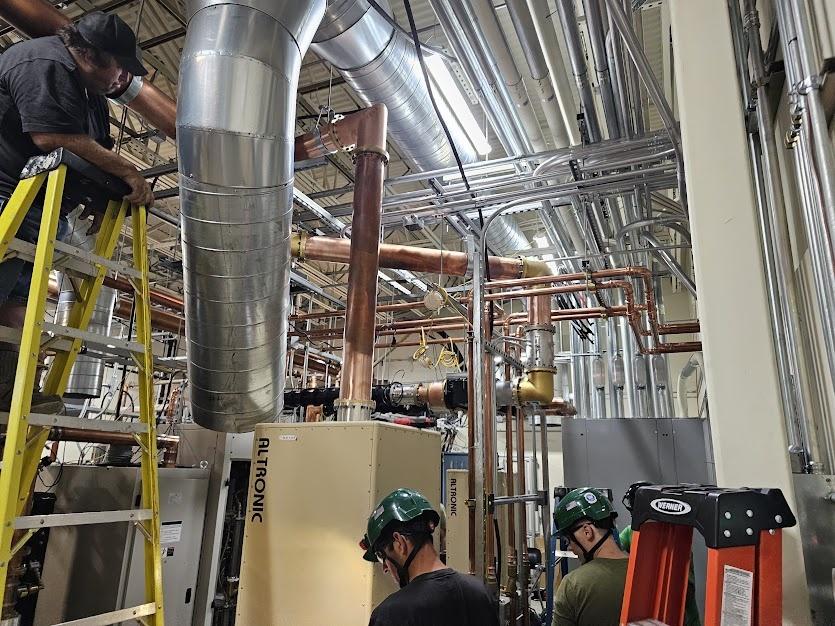 The crew works on equipment at Deer Point transmitter site, July, 2025