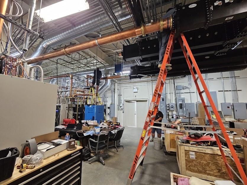 The crew works on equipment at Deer Point transmitter site, July, 2025