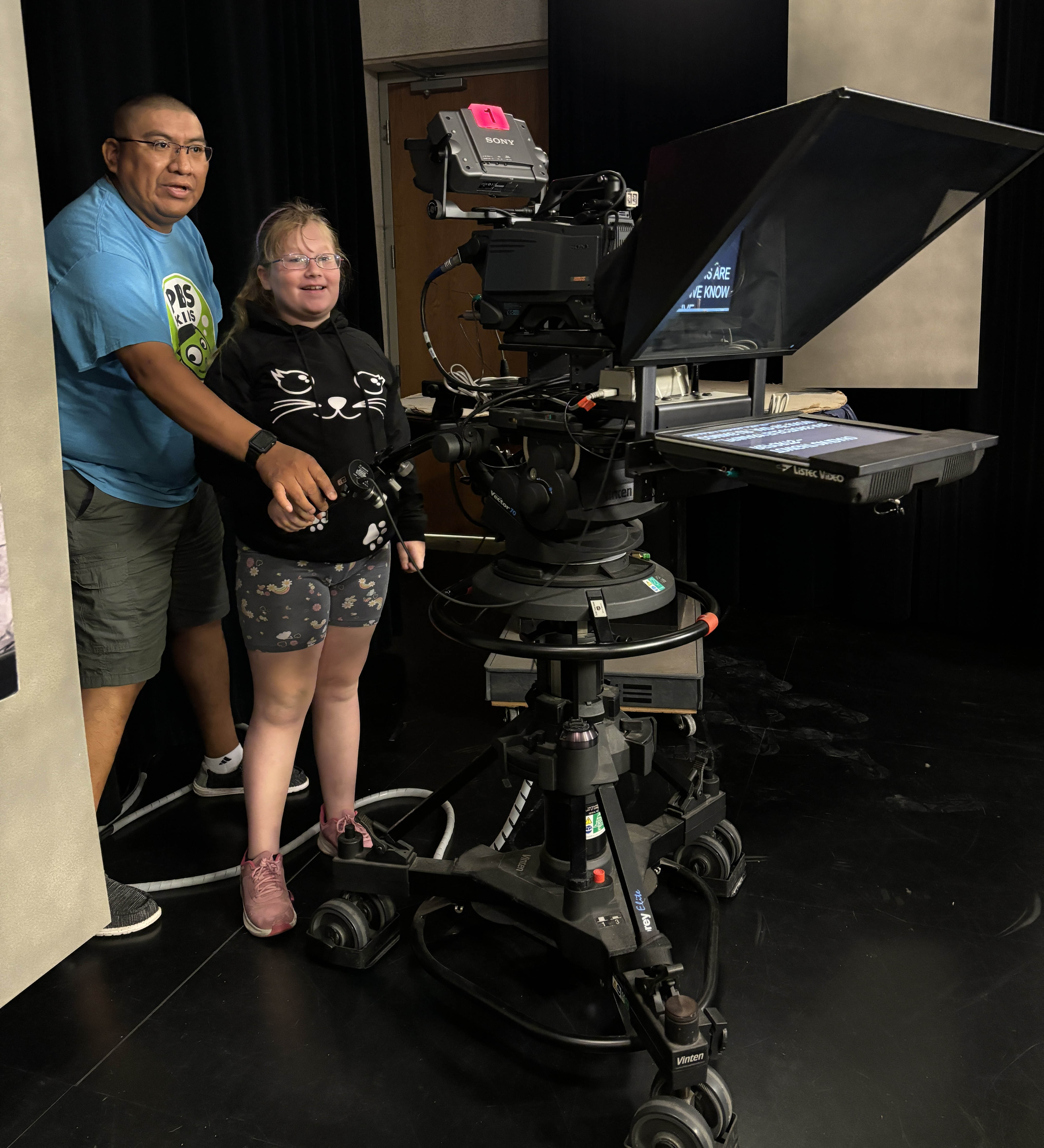 IdahoPTV employee showing a student how to operate a camera