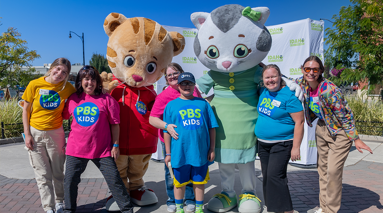 IdahoPTV education team and kid with the cartoon characters Daniel Tiger and Katerina Kittycat