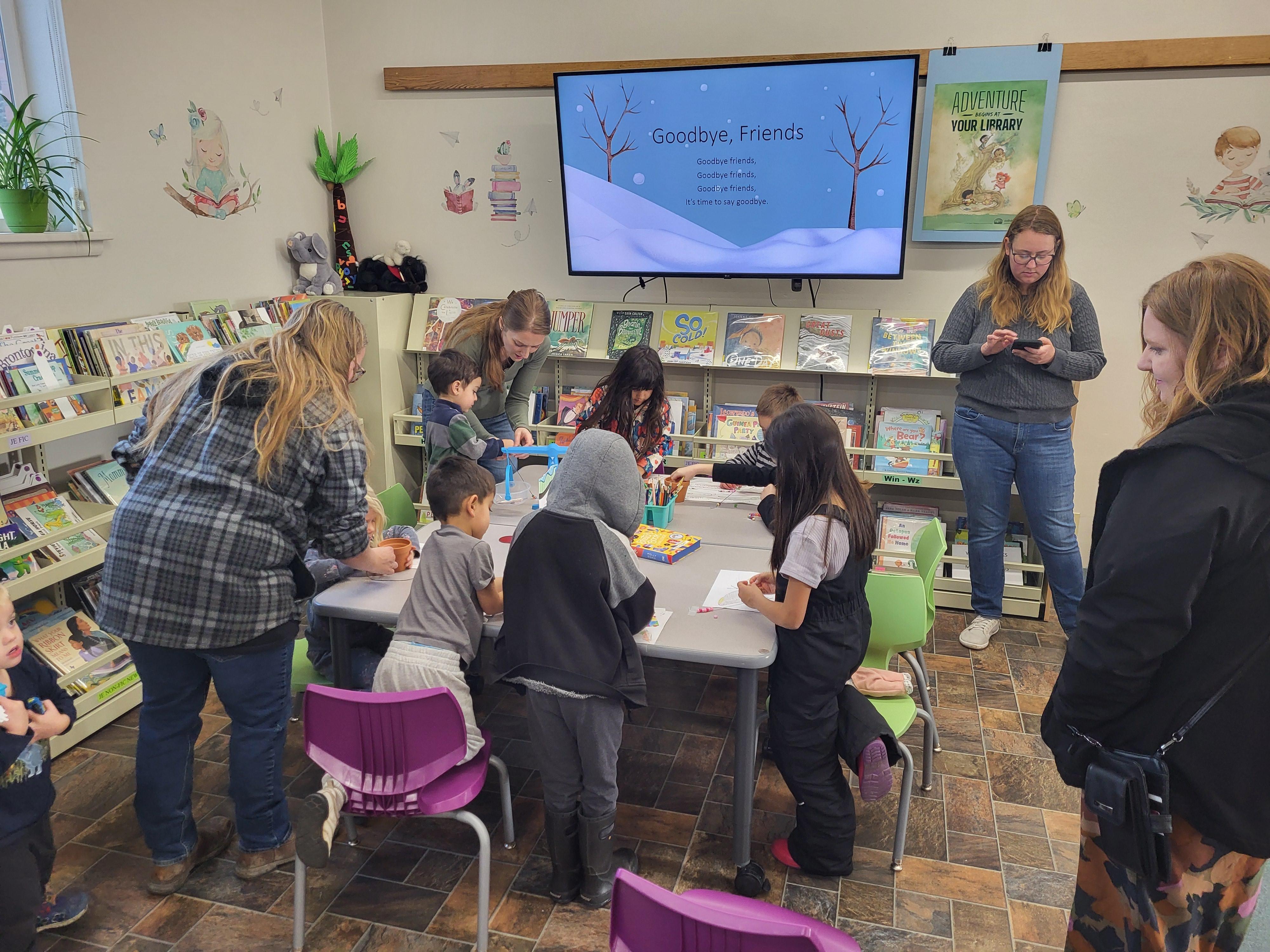 A group of kids sitting around a table doing crafts
