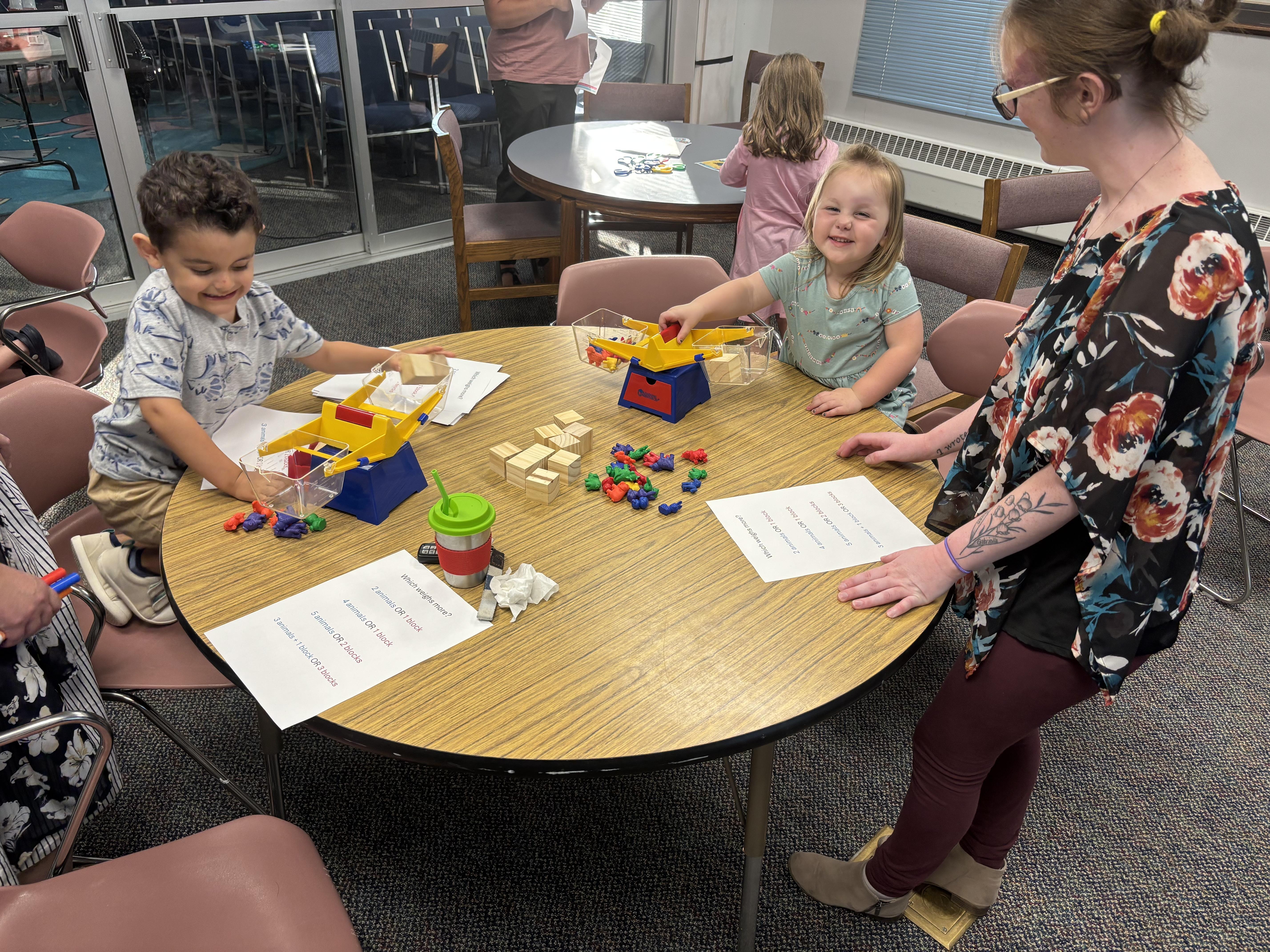 Kids do math activities around a round table