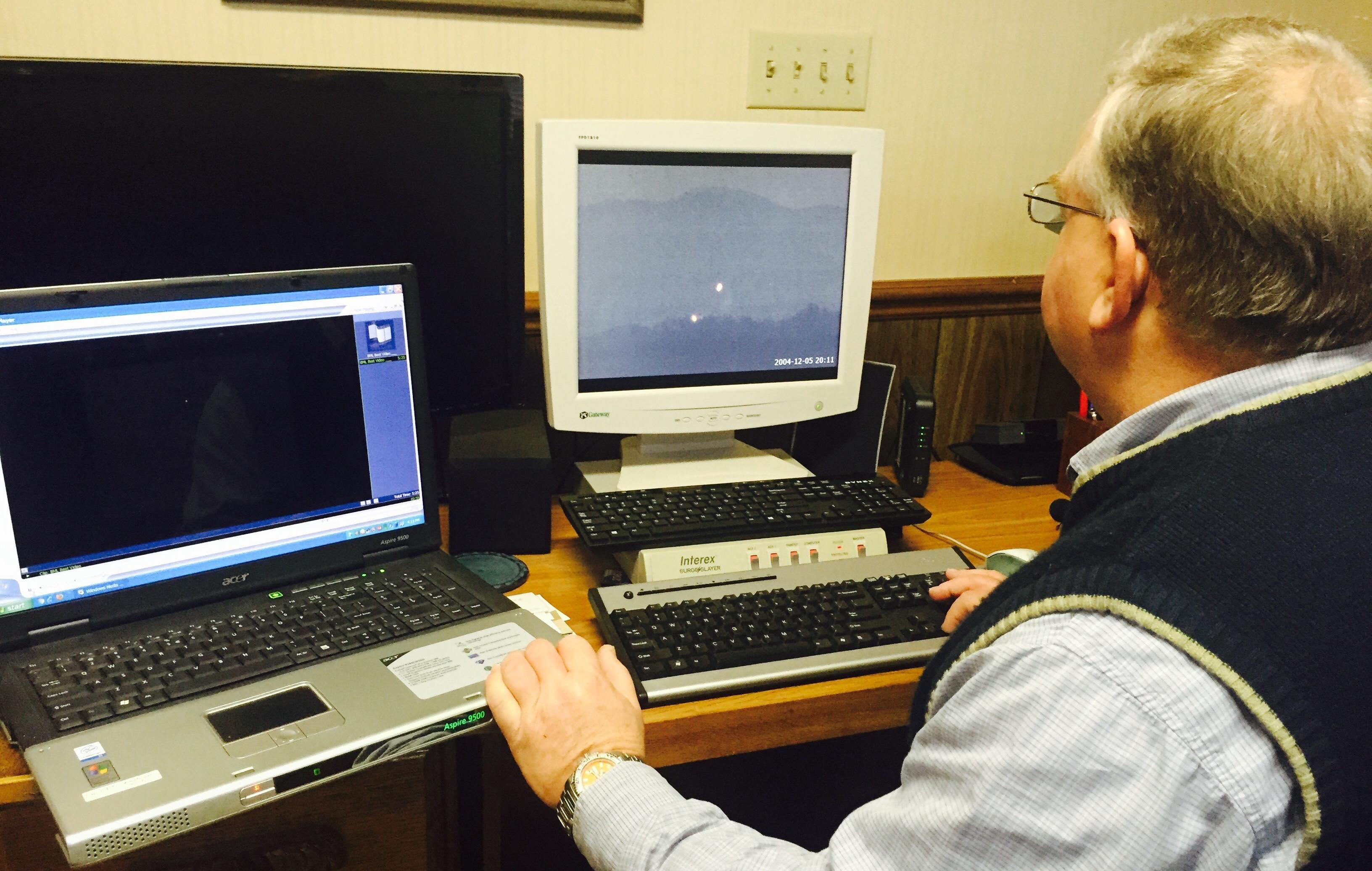Man working at desk on a PC laptop and a desktop on the desk.