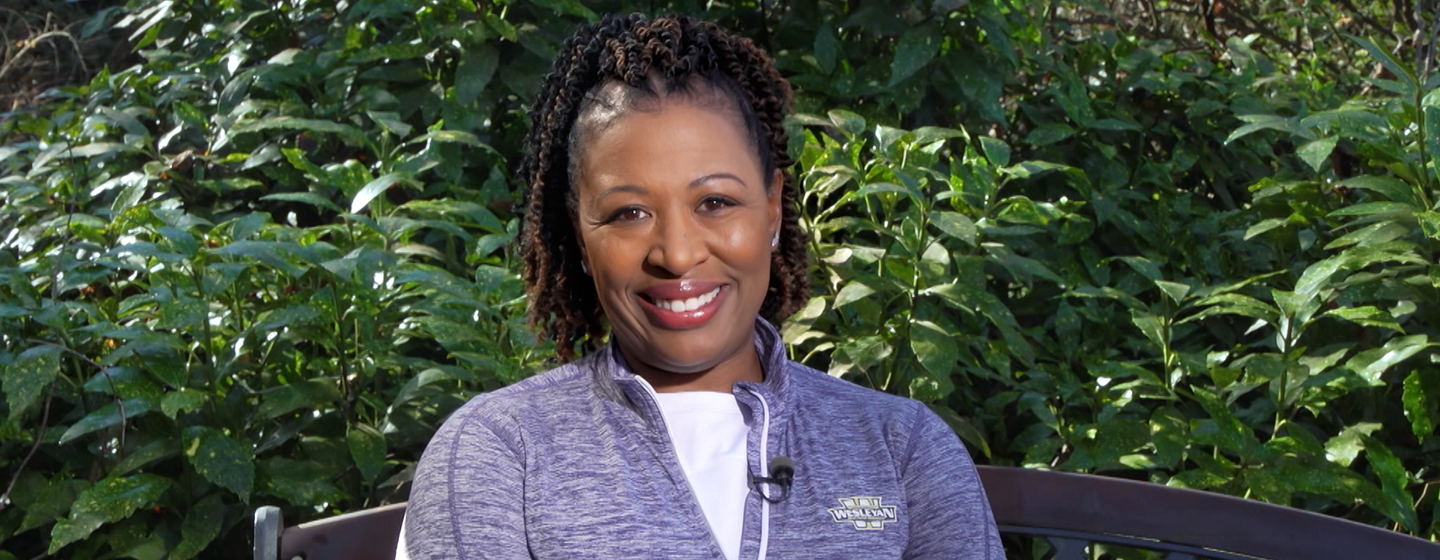 Deb Holt Noel sitting on bench smiling at the camera