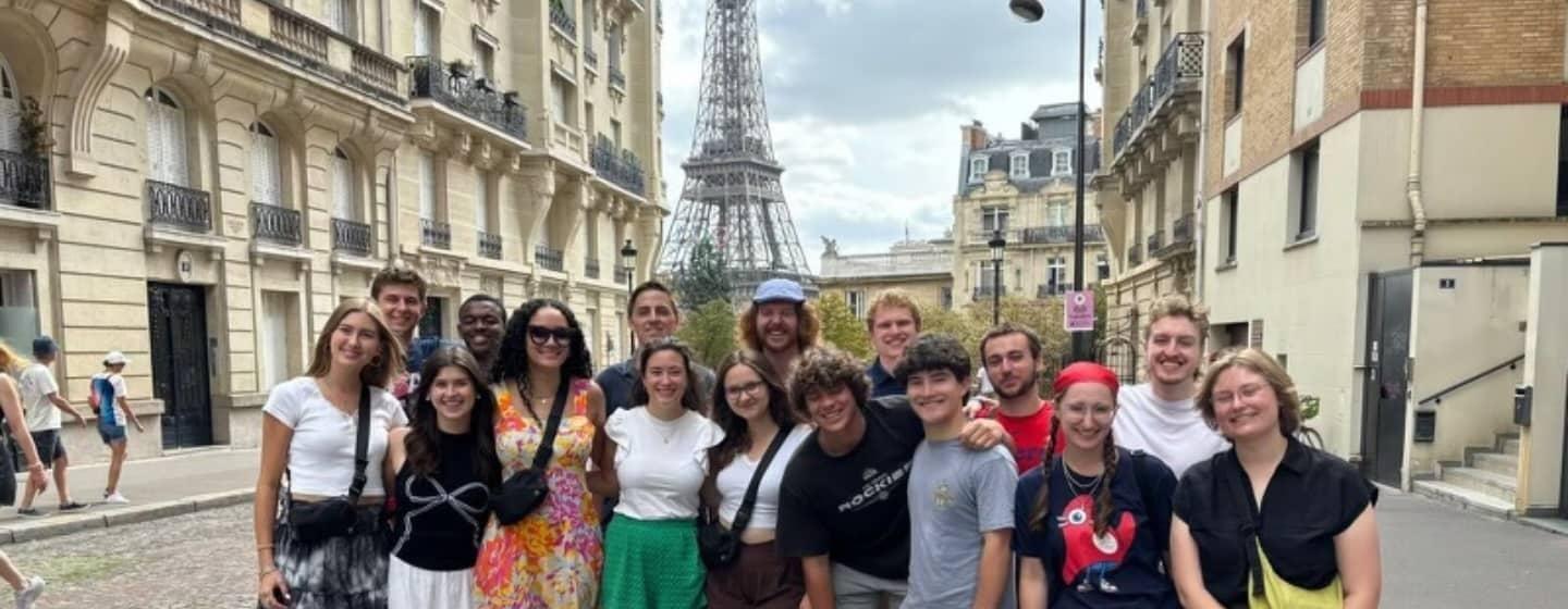 UNC students pose with the Eiffel Tower in the background.