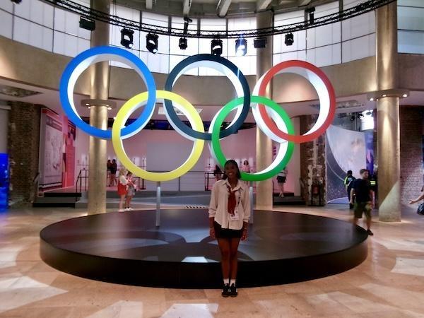 Jasmine Baker poses in front of an art installation of the Olympic rings