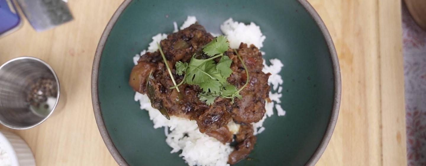 Apple Sabzi plated with white rice underneath