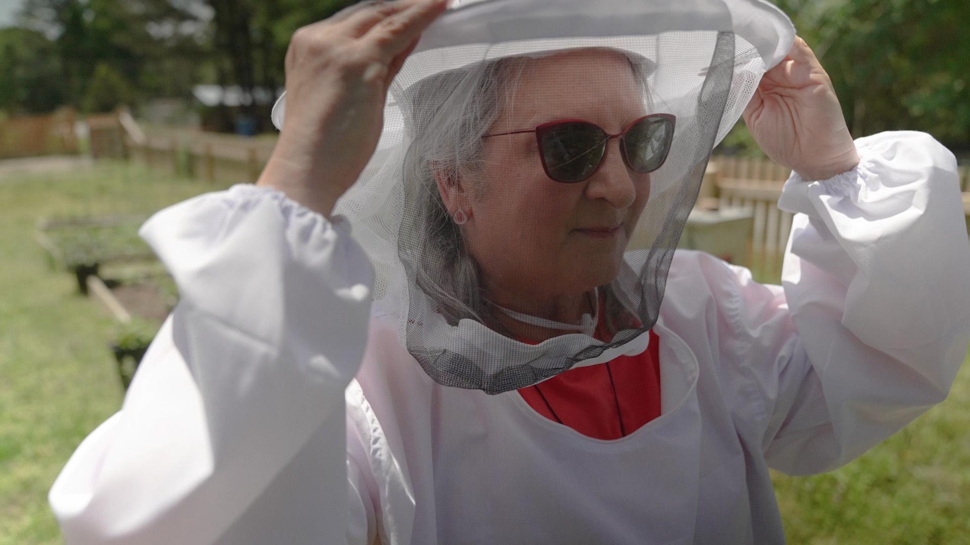 Sheri Castle in a beekeeping suit.