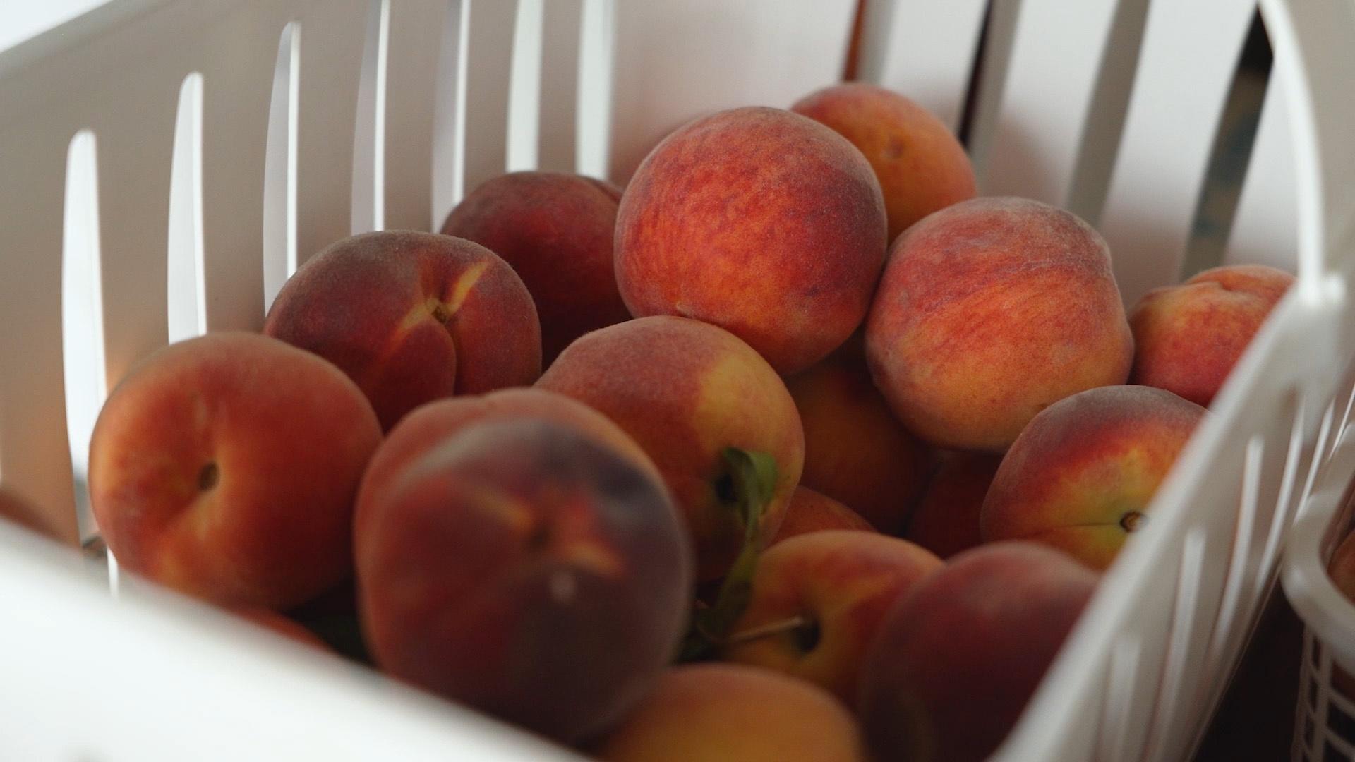 Peaches in a white basket.