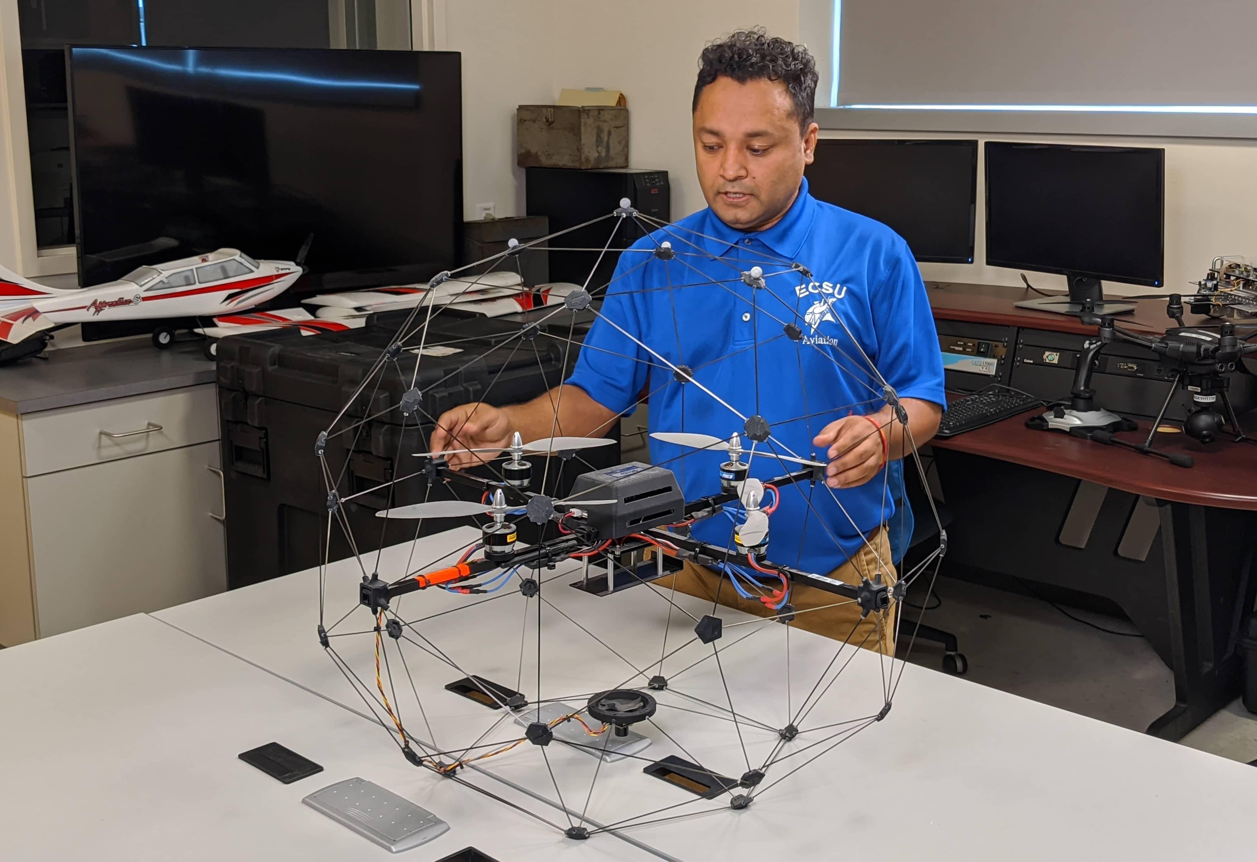 Dr. Kuldeep Rawat, Dean of the School of Science, Aviation, Health and Technology at ECSU holding and building covid drone