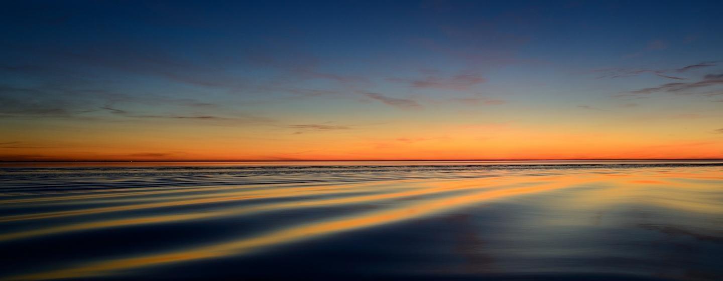 blue and orange sea shortly after sunset dramatic colors calm sea orange and blue