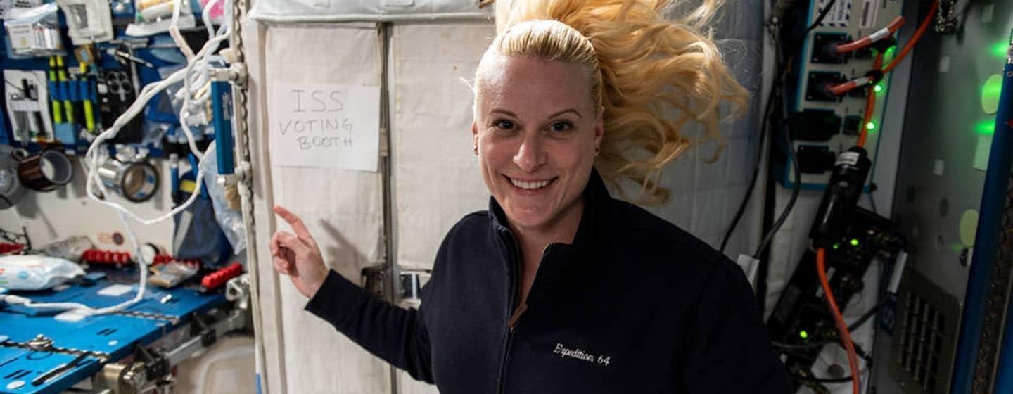 female astronaut kate rubins outside space station voting booth