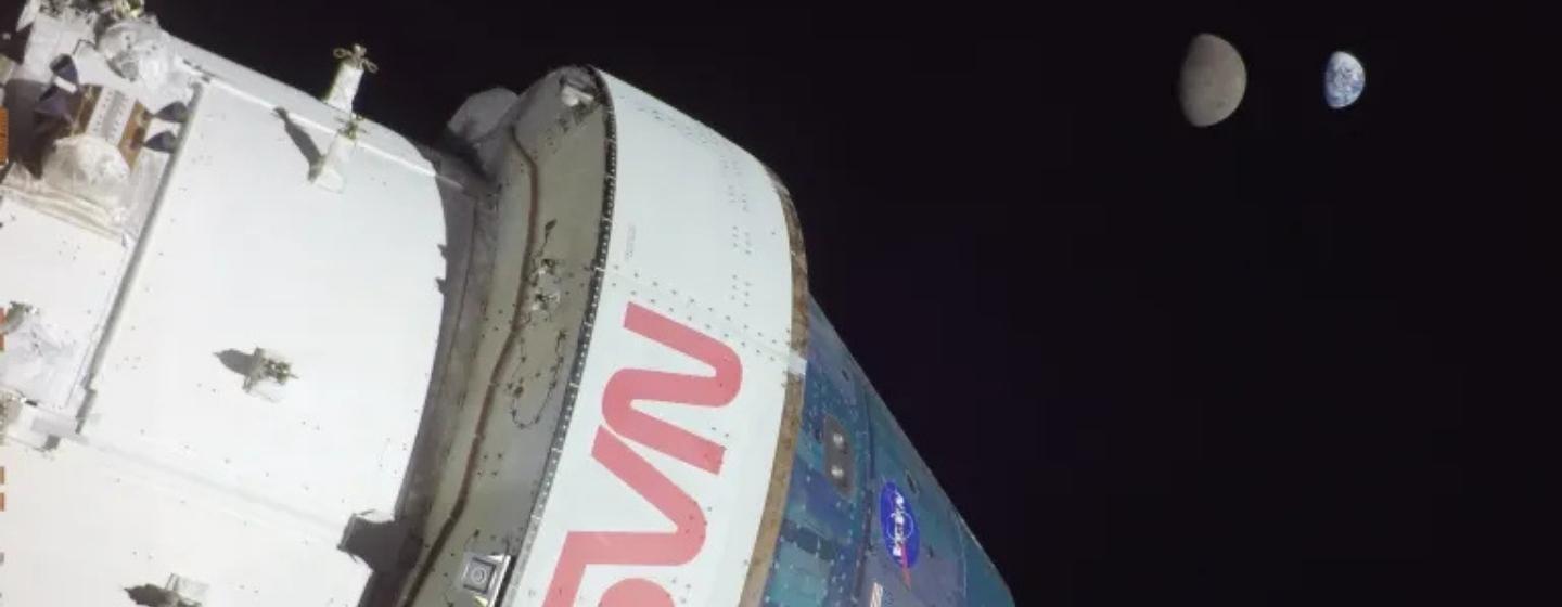 NASA's Artemis I with the earth and moon side by side in the background.