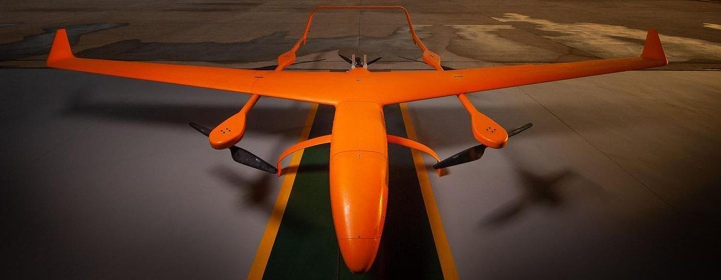 large industrial grade military grade orange drone on runway