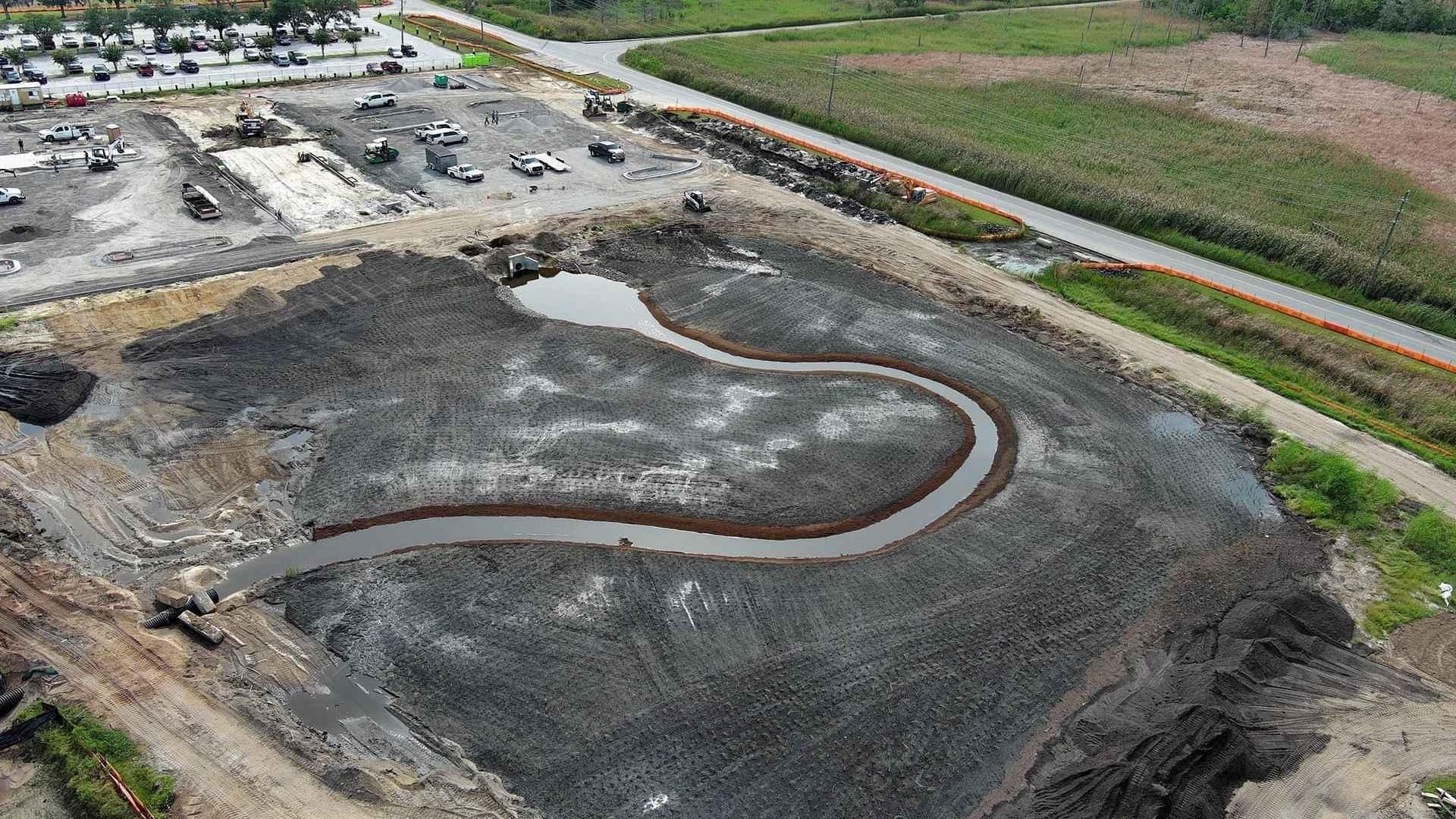 The tidal wetland under construction. The area used to be a frequently flooded parking lot. A bioswale in the newly elevated parking area will drain into the wetland via a storm drain at the top of the tidal creek. Photo courtesy of Dr. Devon Eulie.
