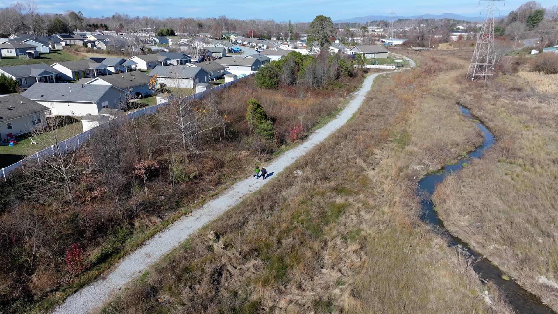 The walking path next to restored Bat Fork Creek is connected to and well used by the adjacent Dodd Meadows Habitat for Humanity community.