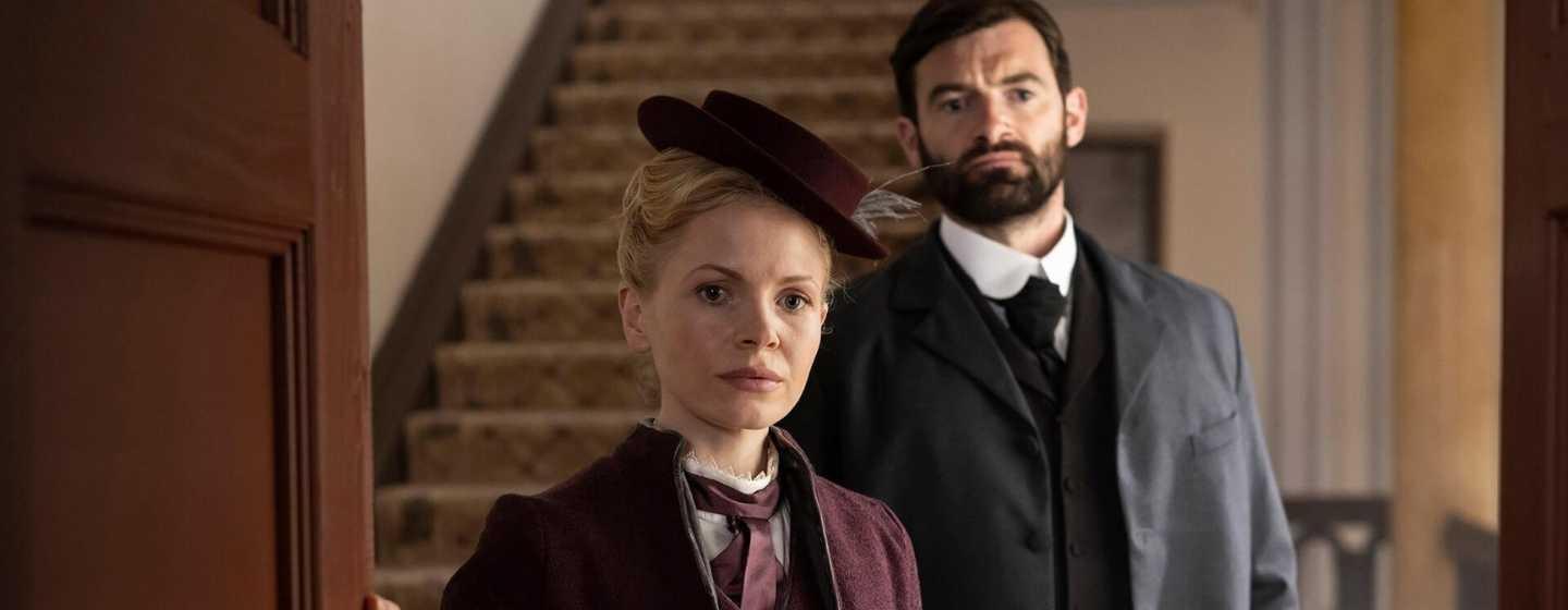 A scene from Miss Scarlet & The Duke Season 2, Eliza in the foreground with William looking on in the background