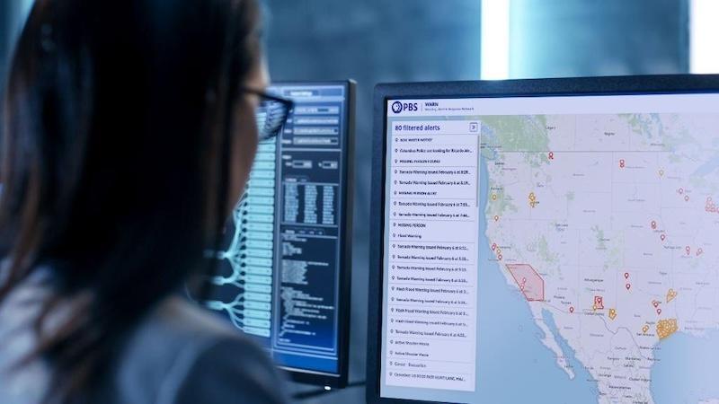 Over the shoulder view of a person looking at the WARN map on their computer