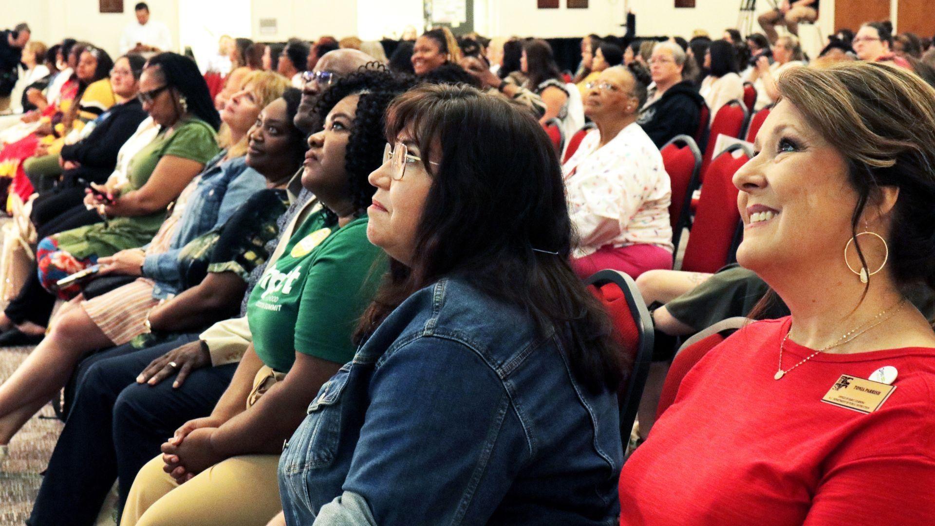woman speaking to audience, Impact Summit