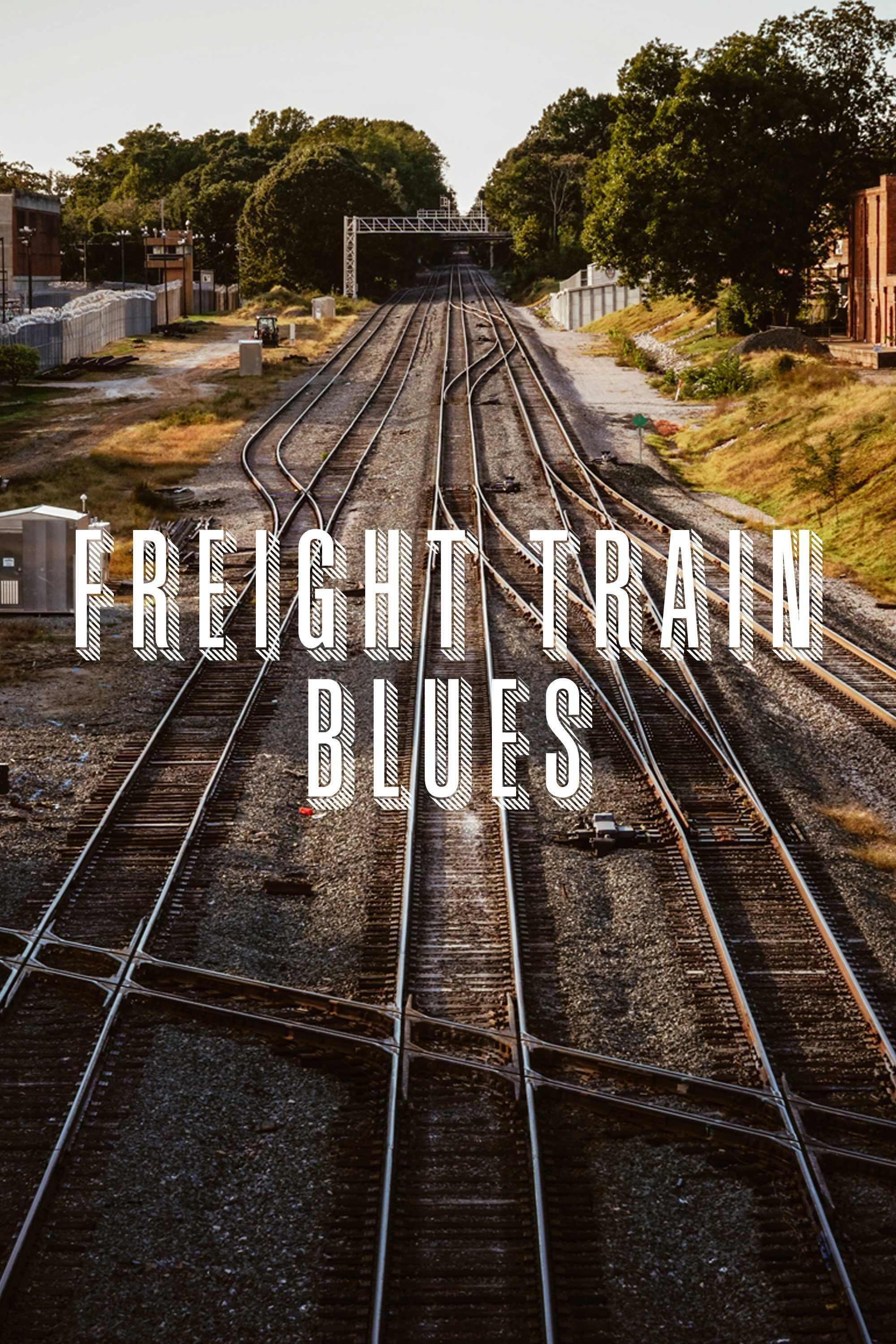 Freight Train Blues logo over a background image of railroad tracks