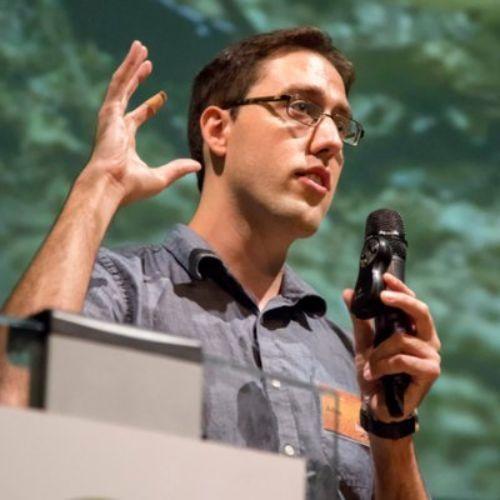 Dr. Adrian Smith speaking at a conference.