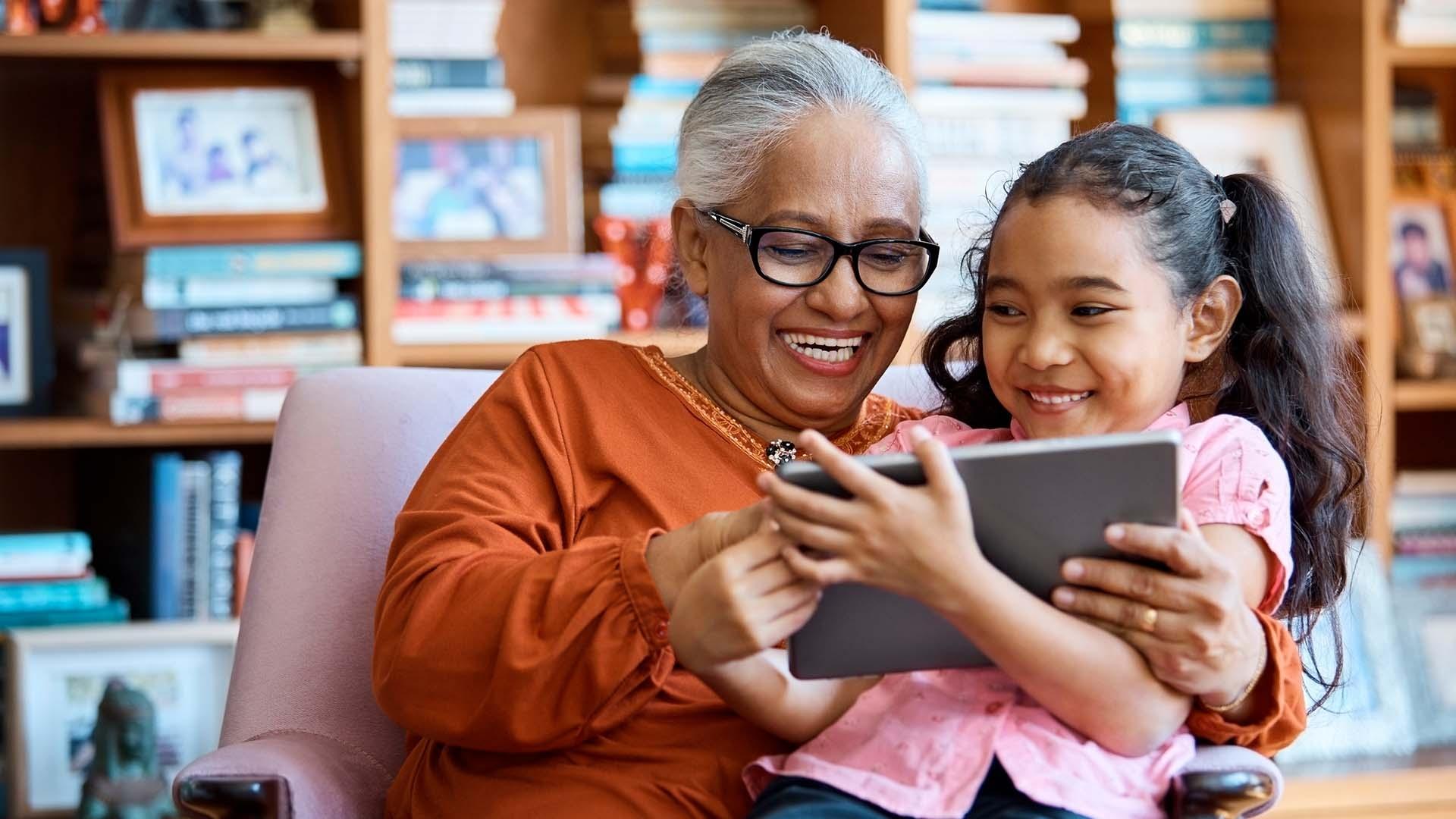 Grandmother and grand daughter enjoying PBS app on tablet