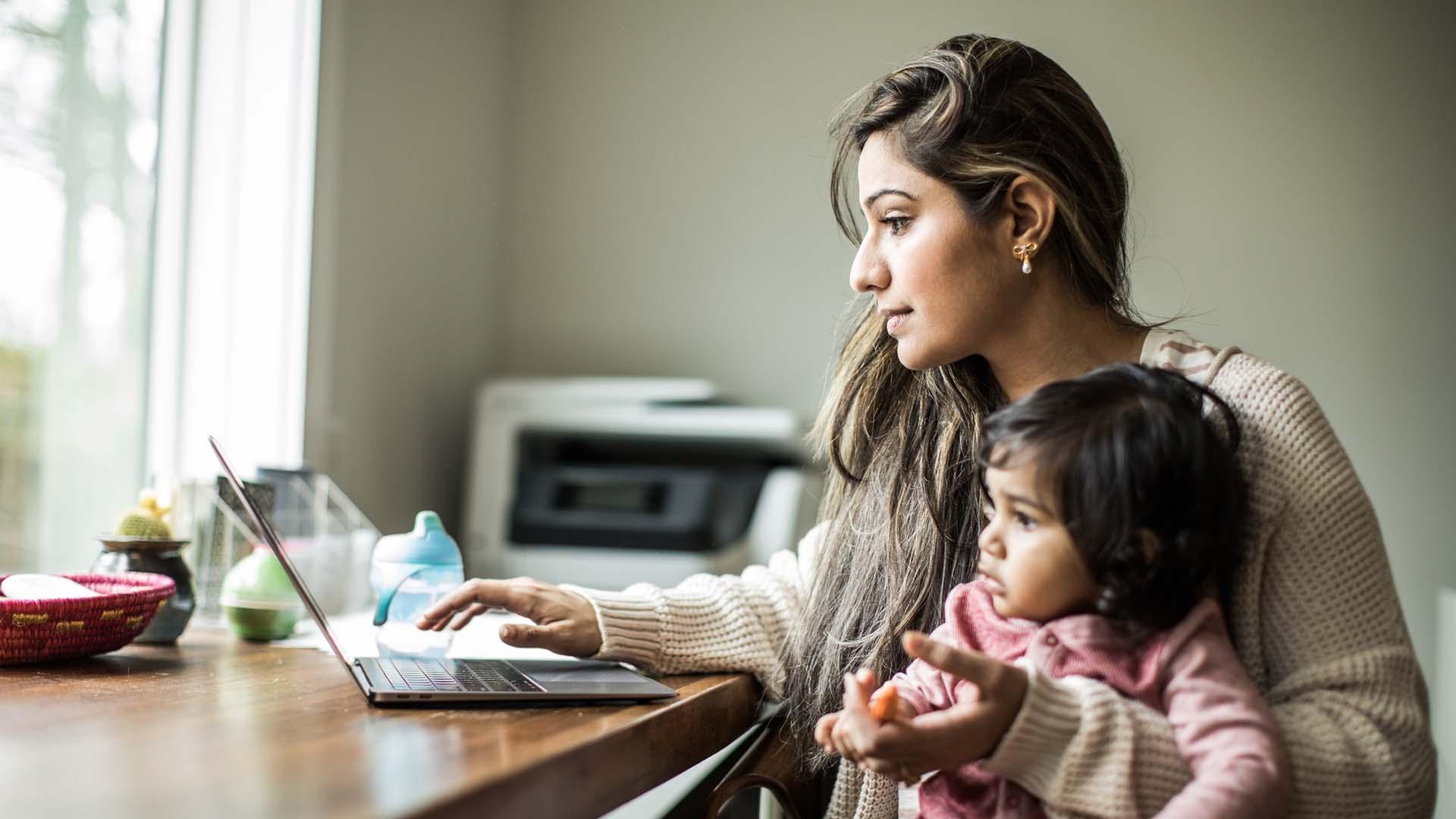 Mom with small child looking at a laptop