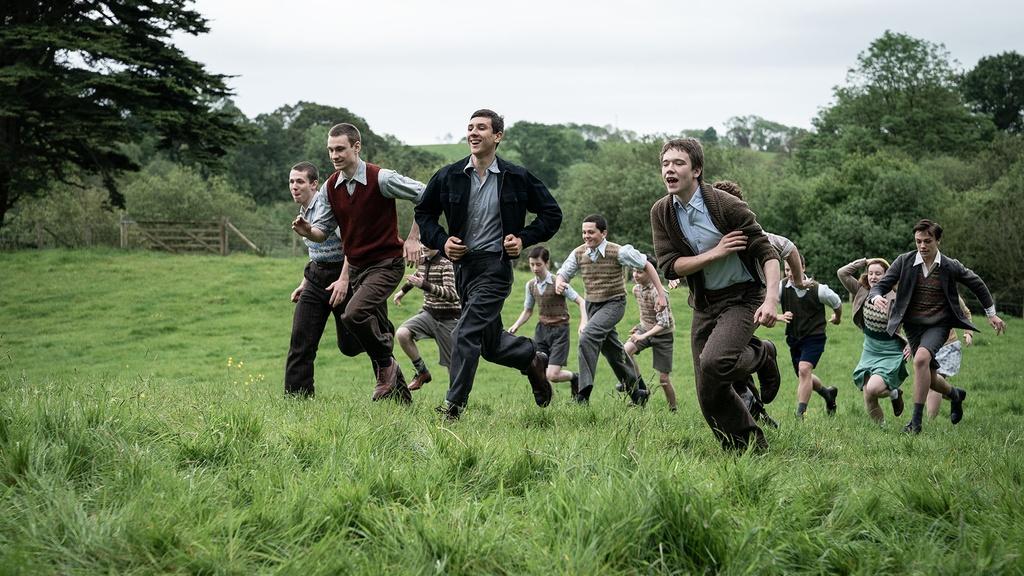 Children running through a field.